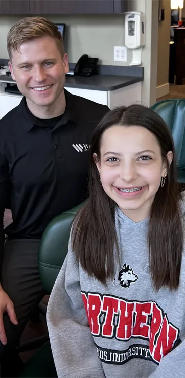 Dr. Daniel Wright with a teenage braces patient after an exam and adjustment