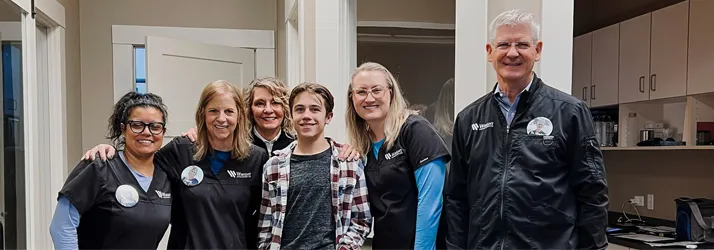 Dr. Randy Wright and team with an Invisalign Teen patient, excited about treatment