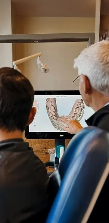 Dr. Randy Wright showing a patient a digital scan of their teeth and gums